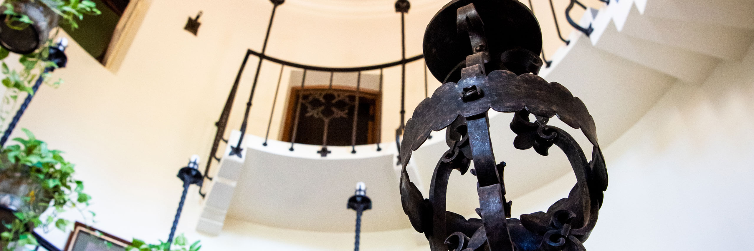 A metal sconce in the spiral stair-well.