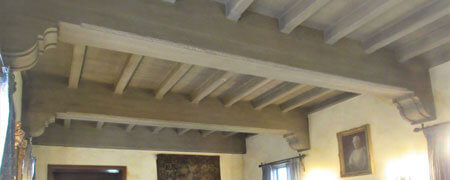 The ceiling of the Ewing Manor living room featuring concrete beams.