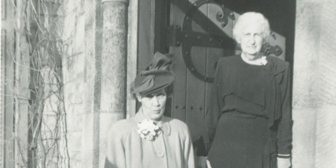 Hazle Buck Ewing and Julia Fairfax Hodge stand on the doorstep of Ewing Manor.