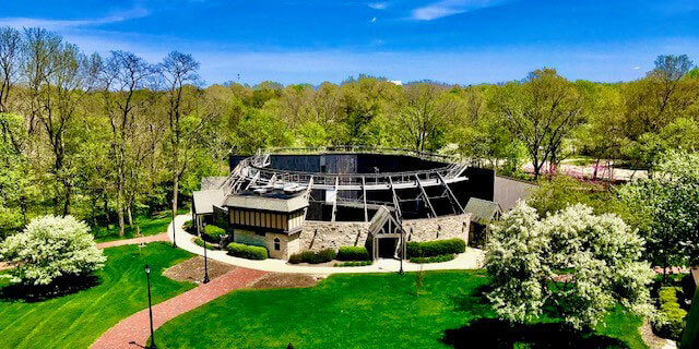 An aerial view of a theatre at Ewing in the middle of a park.