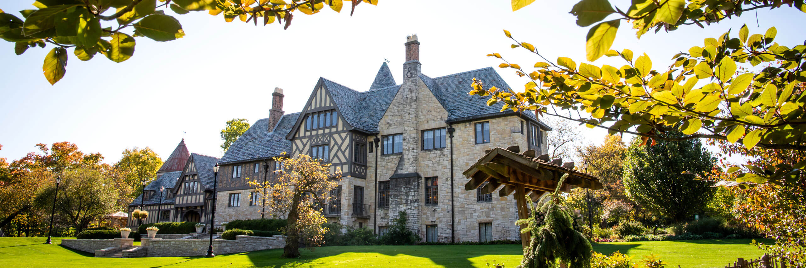 Photo of Ewing Manor through some foliage.