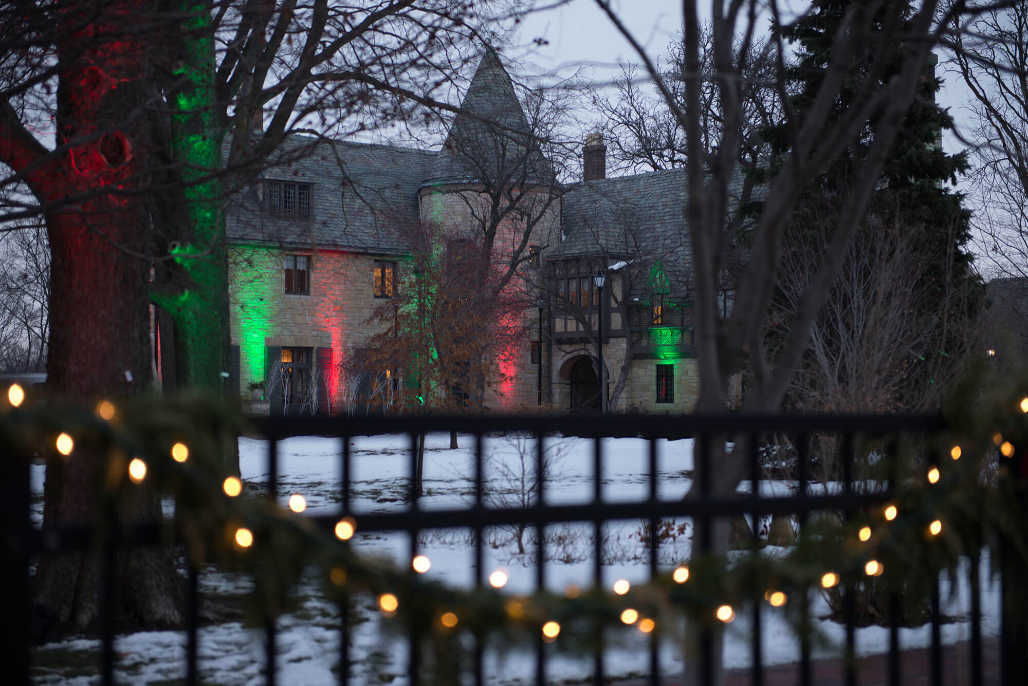 The Ewing Manor lighted up with Christmas lights.