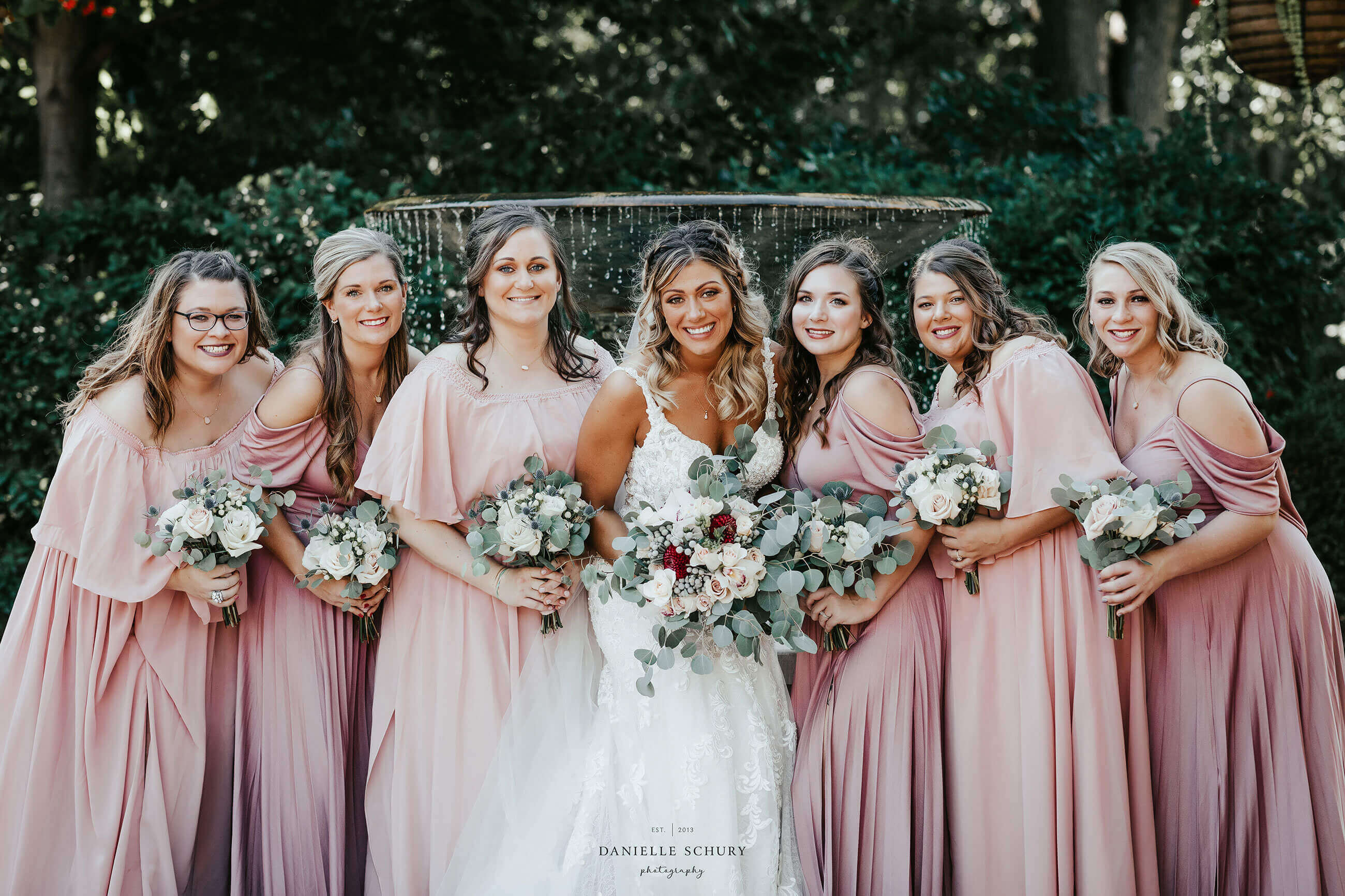 Bride and bridesmaid posing.