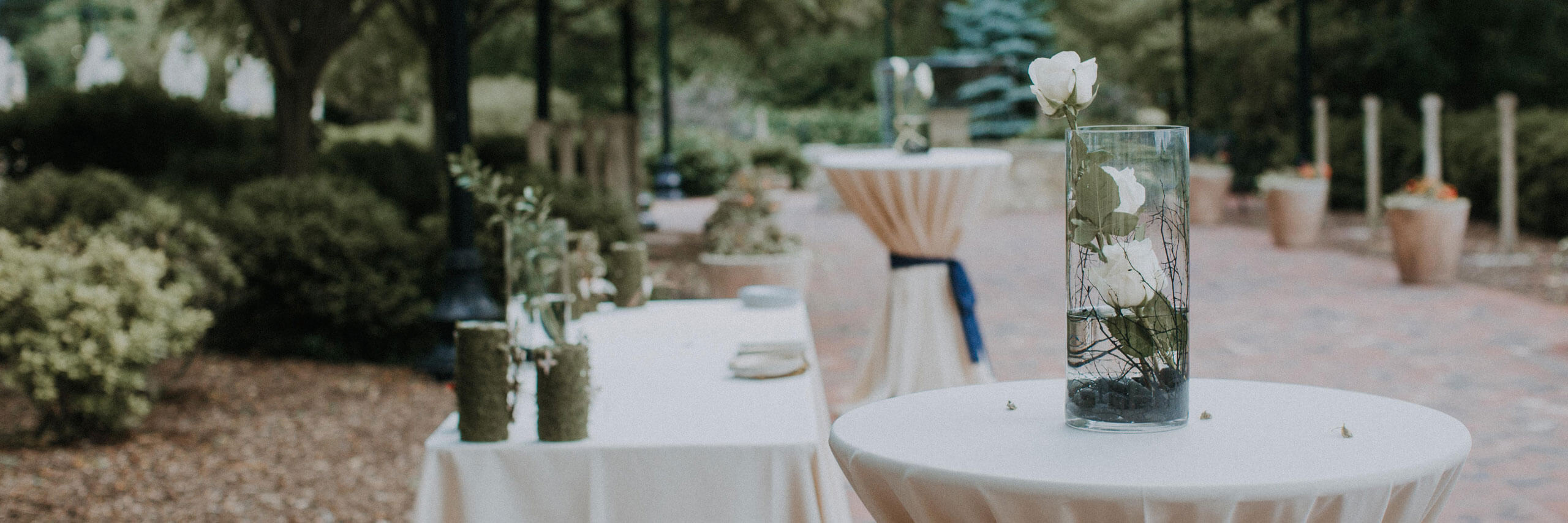 Cocktail tables for an event are set up around the courtyard.